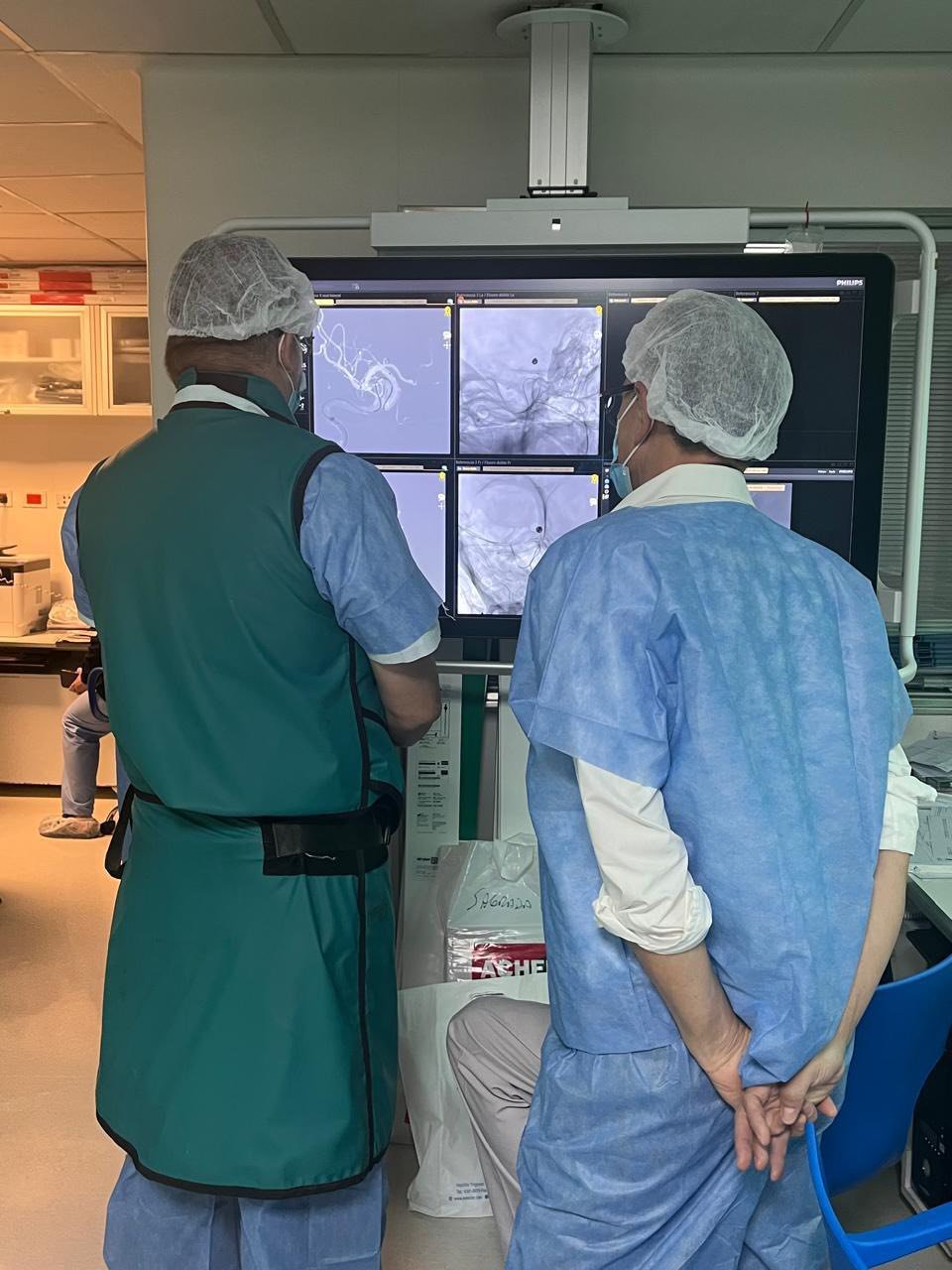 Physicians reviewing angiographic images during a procedure